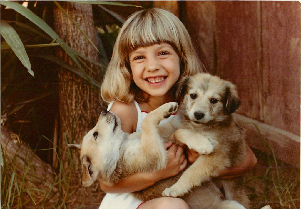 brenna as young girl with puppies